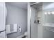 Bathroom featuring a glass shower, toilet, and stackable washer and dryer at 3615 Octavia St, Raleigh, NC 27606