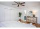 Bedroom with hardwood floors, a ceiling fan, a wooden dresser, and an ensuite bathroom at 3615 Octavia St, Raleigh, NC 27606