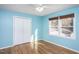 Bedroom featuring natural light, hardwood floors, and a spacious closet at 3615 Octavia St, Raleigh, NC 27606