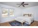 Bright bedroom with hardwood floors, a ceiling fan, and a large window with natural light at 3615 Octavia St, Raleigh, NC 27606