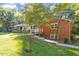 Brick home featuring beautiful landscaping and a charming walkway at 3615 Octavia St, Raleigh, NC 27606