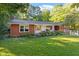 Cozy red brick home with a manicured lawn and beautiful landscaping at 3615 Octavia St, Raleigh, NC 27606