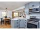 Beautiful kitchen boasts stainless steel appliances and a view into the dining and living areas at 3615 Octavia St, Raleigh, NC 27606