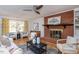 Cozy living room showcasing a brick fireplace, built-in shelves, and ample natural light at 3615 Octavia St, Raleigh, NC 27606