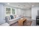 Basement living room with a comfortable sofa, patterned rug, and a bright window at 3615 Octavia St, Raleigh, NC 27606