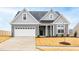 Gray two-story house with white garage door and landscaping at 420 Oak Park Blvd, Youngsville, NC 27596