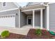 Front entrance with gray siding and a black front door at 420 Oak Park Blvd, Youngsville, NC 27596