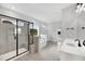 Open bathroom concept features glass shower, tub, and dual sinks at 443 Ravensworth Dr, Garner, NC 27529