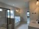 Spacious primary bathroom featuring a soaking tub, glass enclosed shower, and double sink vanity at 443 Ravensworth Dr, Garner, NC 27529