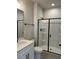 Modern bathroom with a glass enclosed shower, sleek black fixtures, and a white vanity at 443 Ravensworth Dr, Garner, NC 27529