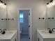 Bathroom featuring dual sinks, granite countertops, and modern fixtures at 443 Ravensworth Dr, Garner, NC 27529