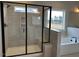 Modern bathroom featuring a glass enclosed shower, soaking tub, and sleek black fixtures at 443 Ravensworth Dr, Garner, NC 27529