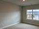 A bright bedroom with plush carpeting and a large window overlooking the yard at 443 Ravensworth Dr, Garner, NC 27529