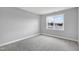 Cozy bedroom with plush carpeting and a large window at 443 Ravensworth Dr, Garner, NC 27529