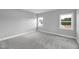 Bright bedroom with dual windows, neutral walls, and plush carpeting offers comfort and style at 443 Ravensworth Dr, Garner, NC 27529