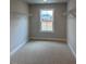 Walk-in closet with neutral walls, plush carpets and a window at 443 Ravensworth Dr, Garner, NC 27529