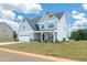 Charming two-story home featuring a light blue exterior, white trim, and an attached two-car garage at 443 Ravensworth Dr, Garner, NC 27529
