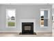 Inviting fireplace framed by windows, creating a cozy focal point in the room at 443 Ravensworth Dr, Garner, NC 27529