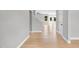Inviting entryway with light wood floors, white trim, and a view of the staircase and living area at 443 Ravensworth Dr, Garner, NC 27529