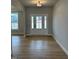 Bright foyer featuring hardwood floors, a large front door with sidelights, and neutral wall colors at 443 Ravensworth Dr, Garner, NC 27529