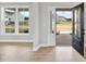 Bright entryway with light wood floors and a view to a front yard and house across the street at 443 Ravensworth Dr, Garner, NC 27529