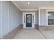 Close-up of a blue front door framed by white trim and brick base, creating a welcoming entrance at 443 Ravensworth Dr, Garner, NC 27529