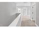 Hallway with neutral walls, carpeted flooring, and multiple doorways at 443 Ravensworth Dr, Garner, NC 27529