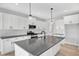 Stylish kitchen featuring a large island, white cabinets, and stainless steel appliances at 443 Ravensworth Dr, Garner, NC 27529