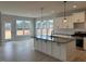 Modern kitchen featuring an island with pendant lights, stainless steel appliances, and hardwood floors at 443 Ravensworth Dr, Garner, NC 27529