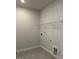 Spacious laundry room featuring ceramic tile floors and metal rack shelving at 443 Ravensworth Dr, Garner, NC 27529