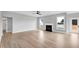 Bright living room with light wood flooring, fireplace, and abundant natural light at 443 Ravensworth Dr, Garner, NC 27529