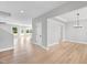 Bright and open-concept living space featuring light wood floors and white walls, creating a welcoming atmosphere at 443 Ravensworth Dr, Garner, NC 27529
