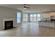 Spacious living room with hardwood floors, fireplace, large windows, and open concept with kitchen at 443 Ravensworth Dr, Garner, NC 27529