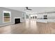Open-concept living space with fireplace, lots of natural light, and modern finishes at 443 Ravensworth Dr, Garner, NC 27529
