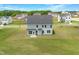Aerial shot of a two-story home with a spacious backyard and blue siding at 443 Ravensworth Dr, Garner, NC 27529