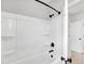 Bright shower with black hardware, a white tub, and multiple shelves at 443 Ravensworth Dr, Garner, NC 27529