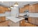 Modern kitchen with light wood cabinets, a large island, and stainless steel appliances at 607 Hillfarm Dr, Wake Forest, NC 27587