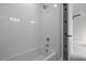 Modern bathtub and shower feature white subway tile and sleek fixtures at 3723 Bellevue Rd, Raleigh, NC 27609