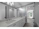 Bright bathroom featuring a double sink vanity with quartz countertop and modern lighting at 3723 Bellevue Rd, Raleigh, NC 27609