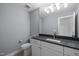Neutral toned bathroom featuring sleek cabinets, stone countertops, and modern vanity lighting at 3723 Bellevue Rd, Raleigh, NC 27609