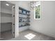 Bright bedroom featuring custom blue built-in shelves and modern light fixture at 3723 Bellevue Rd, Raleigh, NC 27609