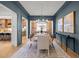 Elegant dining room with modern light fixture, bar area, and hardwood flooring at 3723 Bellevue Rd, Raleigh, NC 27609