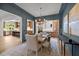 Elegant dining room with modern light fixture, bar area, and hardwood flooring at 3723 Bellevue Rd, Raleigh, NC 27609