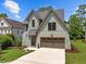 Two-story home featuring neutral color palette, driveway, large two-car garage, and green lawn at 3723 Bellevue Rd, Raleigh, NC 27609