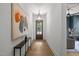 Inviting hallway with hardwood floors, modern lighting, and stylish artwork at 3723 Bellevue Rd, Raleigh, NC 27609