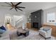 Bright living room with a fireplace, hardwood floors, and stylish ceiling fan at 3723 Bellevue Rd, Raleigh, NC 27609