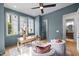 Comfortable home office with blue walls, natural light, and modern furnishings at 3723 Bellevue Rd, Raleigh, NC 27609
