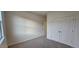 Clean, carpeted bedroom with double door closet and a view, providing comfort and functionality at 141 Robert Howe Dr, Fuquay Varina, NC 27526