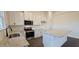 Contemporary kitchen featuring an island, granite countertops, stainless steel appliances, and white cabinets at 141 Robert Howe Dr, Fuquay Varina, NC 27526