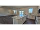 Modern kitchen featuring white cabinets, stainless steel appliances, granite countertops, and an island at 141 Robert Howe Dr, Fuquay Varina, NC 27526